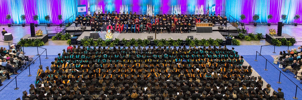 commencement audience aerial shot shows a sea of caps and gowns