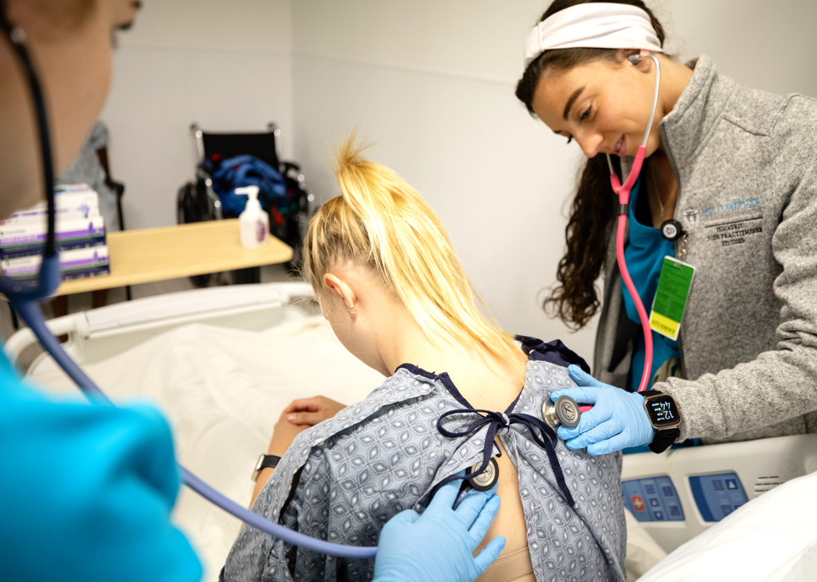 A student in the Direct-Entry Master's in Nursing Program performing a clinical assessment during a hands-on training session