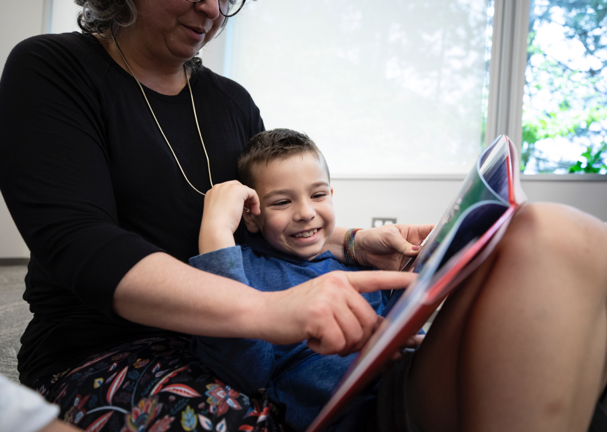A woman reading to a young child
