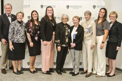 Dean Ken White (left) and President Paula Milone-Nuzzo  (second from left) join SON nursing students and MGH NAA leadership in celebrating the association's annual homecoming 
