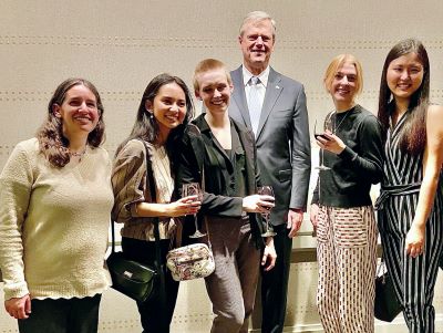 Five student advocates stand with Governor Baker.