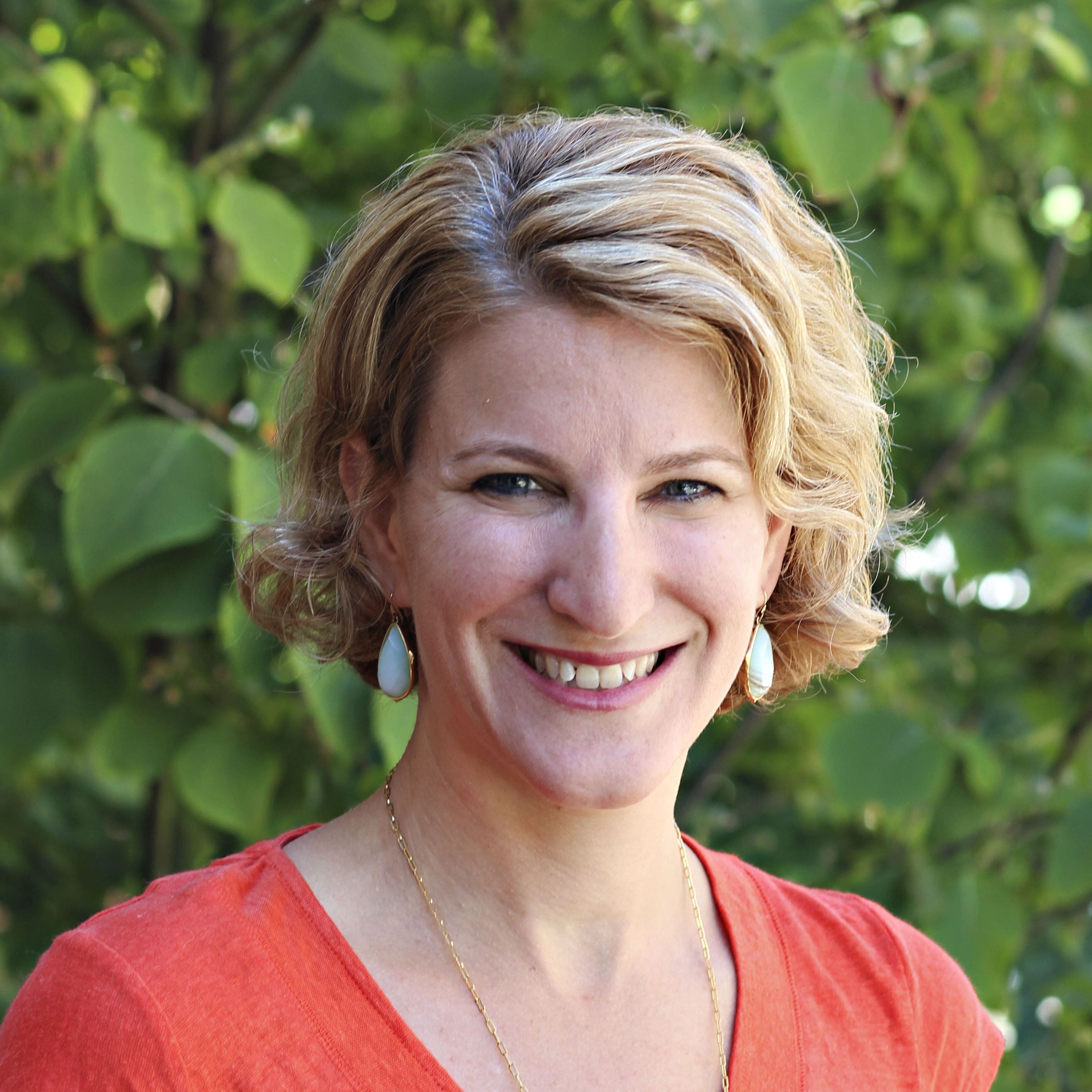 Headshot of an MGH IHP faculty member for the Doctor of Audiology program, outdoors with a natural background.
