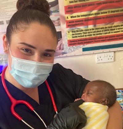 leah holds a tiny Ugandan baby
