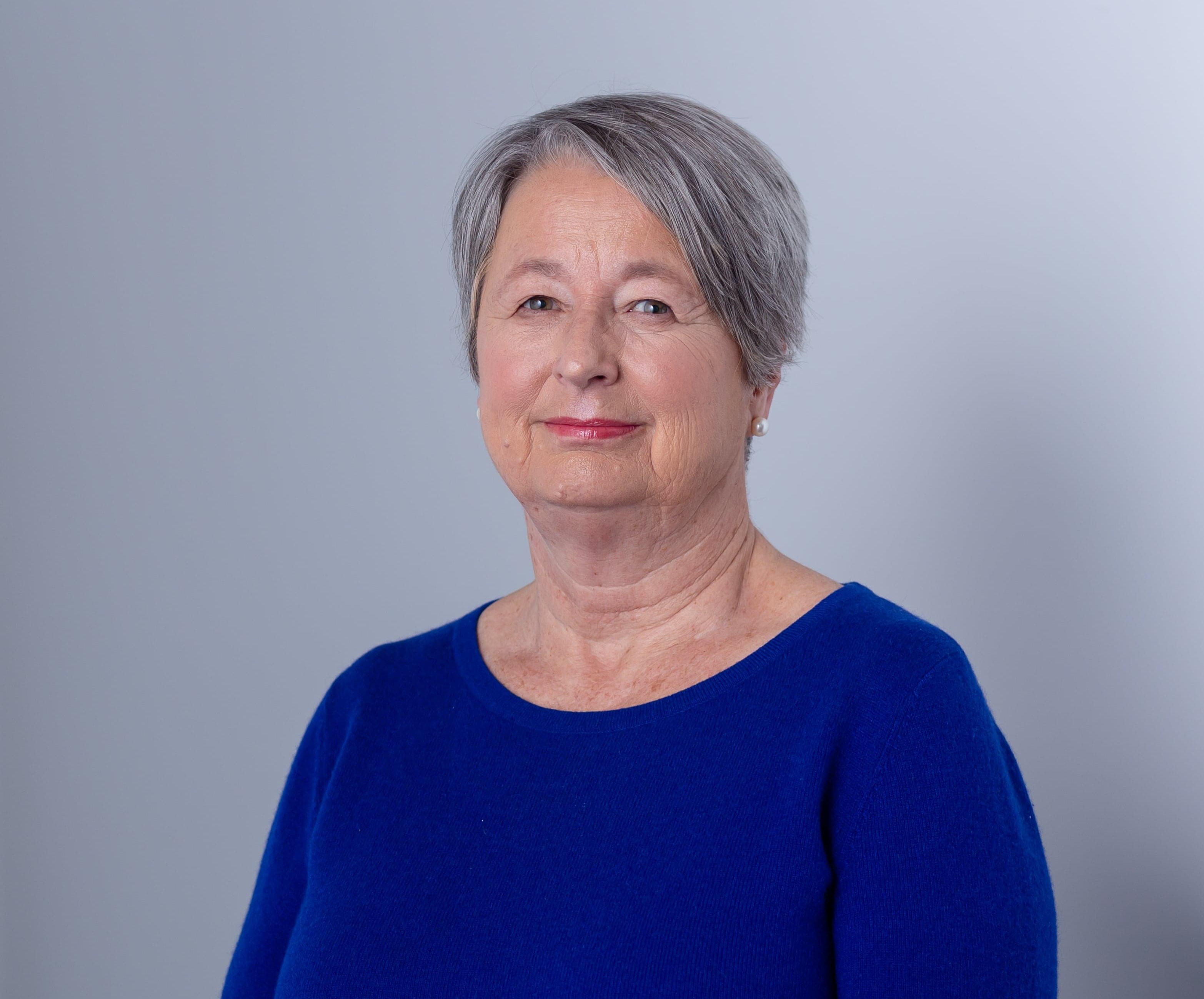 Rita Olans in blue shirt