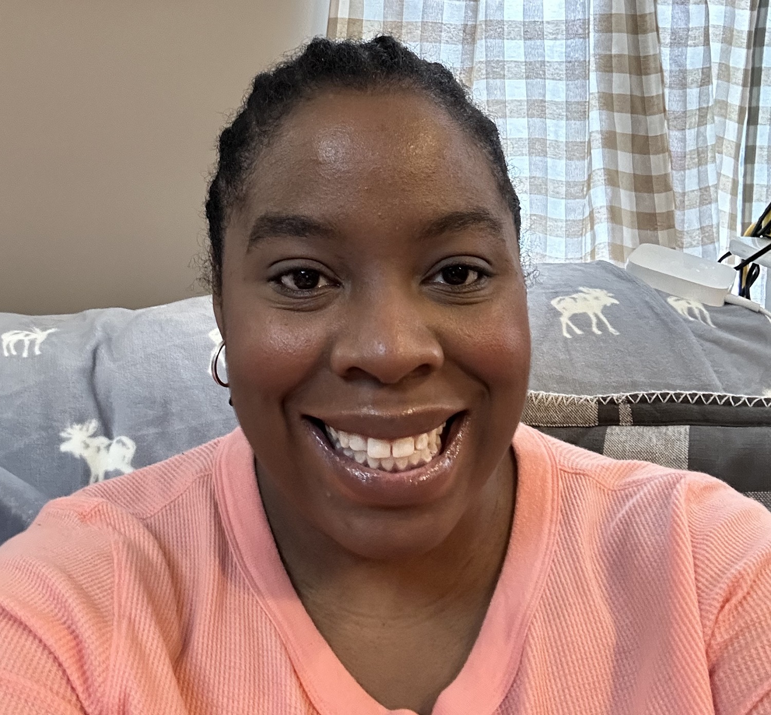 keyona wears a peach shirt and has her black hair in braids