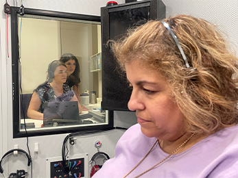 First-year audiology student Lily Fischer looks over the shoulder of Dr. Anita Mepani, a clinician with Mass Eye and Ear. They were gauging the hearing loss in patient Halla Jadallah, who visited the new MEE clinic 