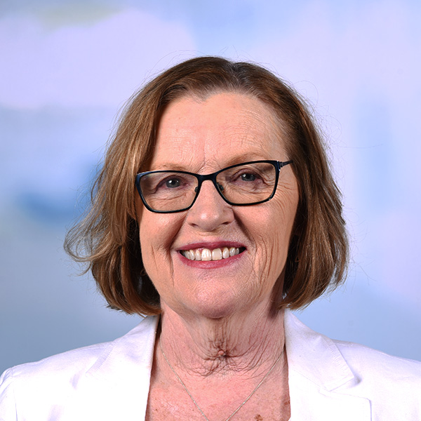 susan has a white jacket and dark pink lipstick she wears glasses