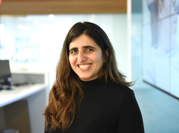 Pooja Jethani has long dark hair and is in a black shirt