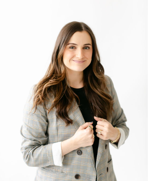 Brittany Palaski in black shirt and plaid grey blazer