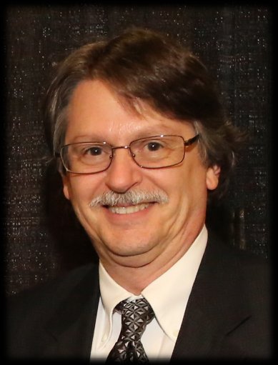 mark has a moustache and wears a suit and tie