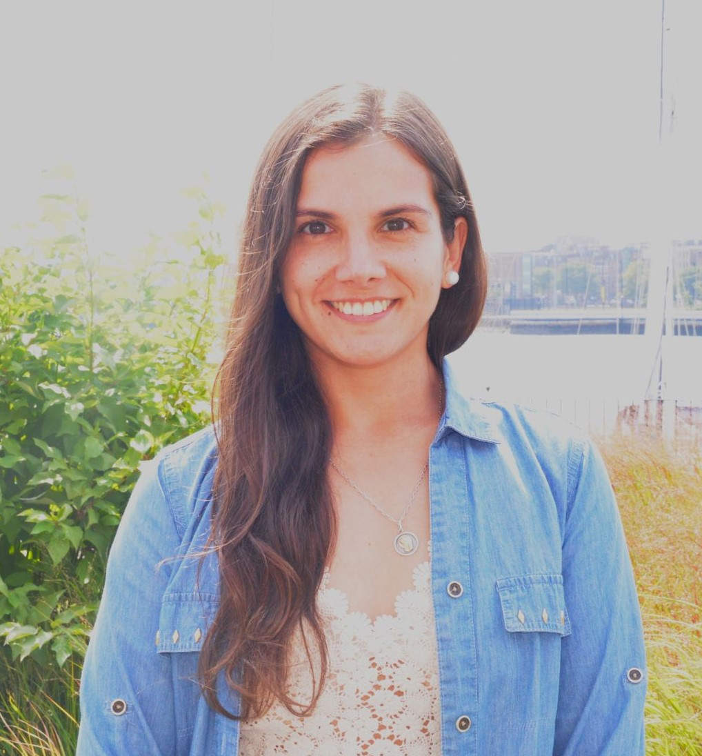 Nadine Alejandra Aranis Seguic has long brown hair and is wearing a blue denim jacket and white lace shirt