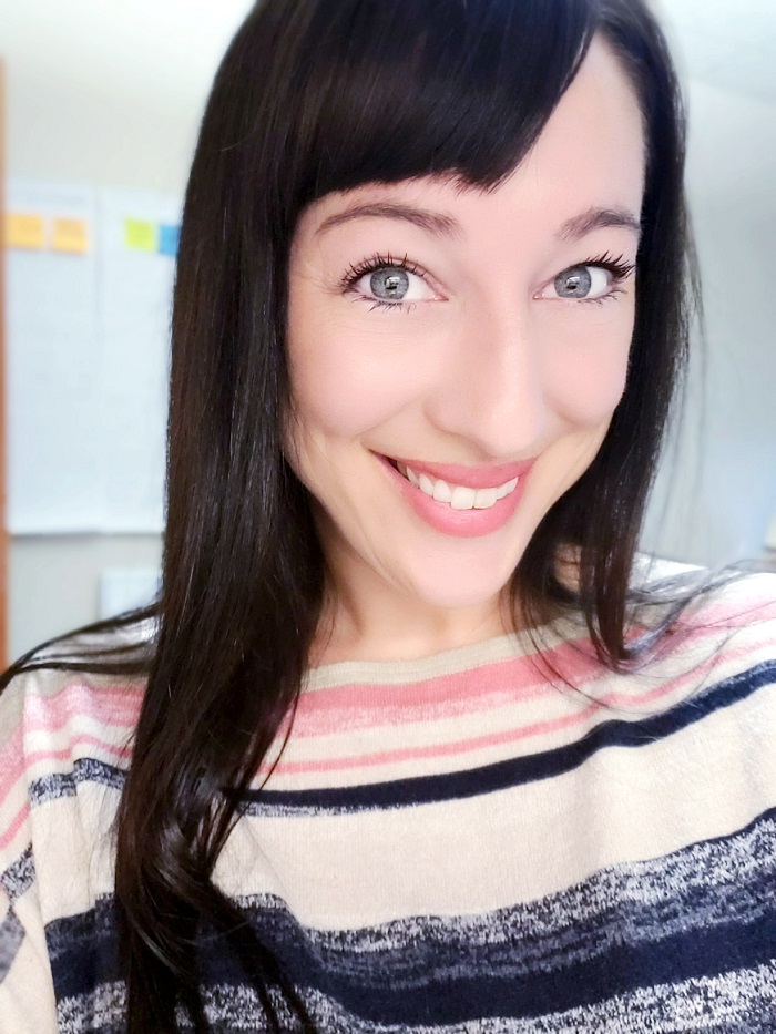 sarah has a pink and blue striped shirt and straight black hair