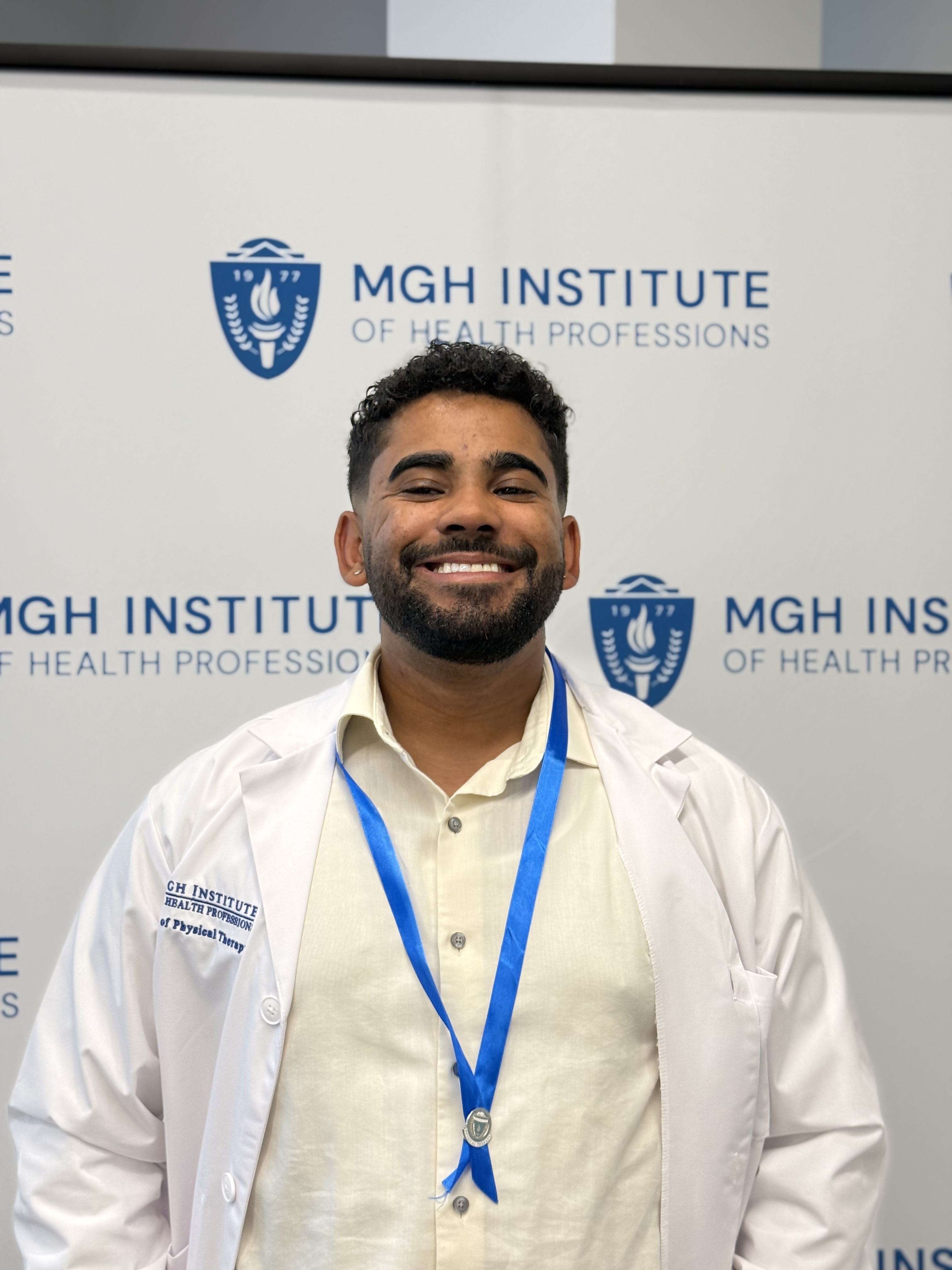 Jimaldy wears a white lab coat and has a beard and mustache