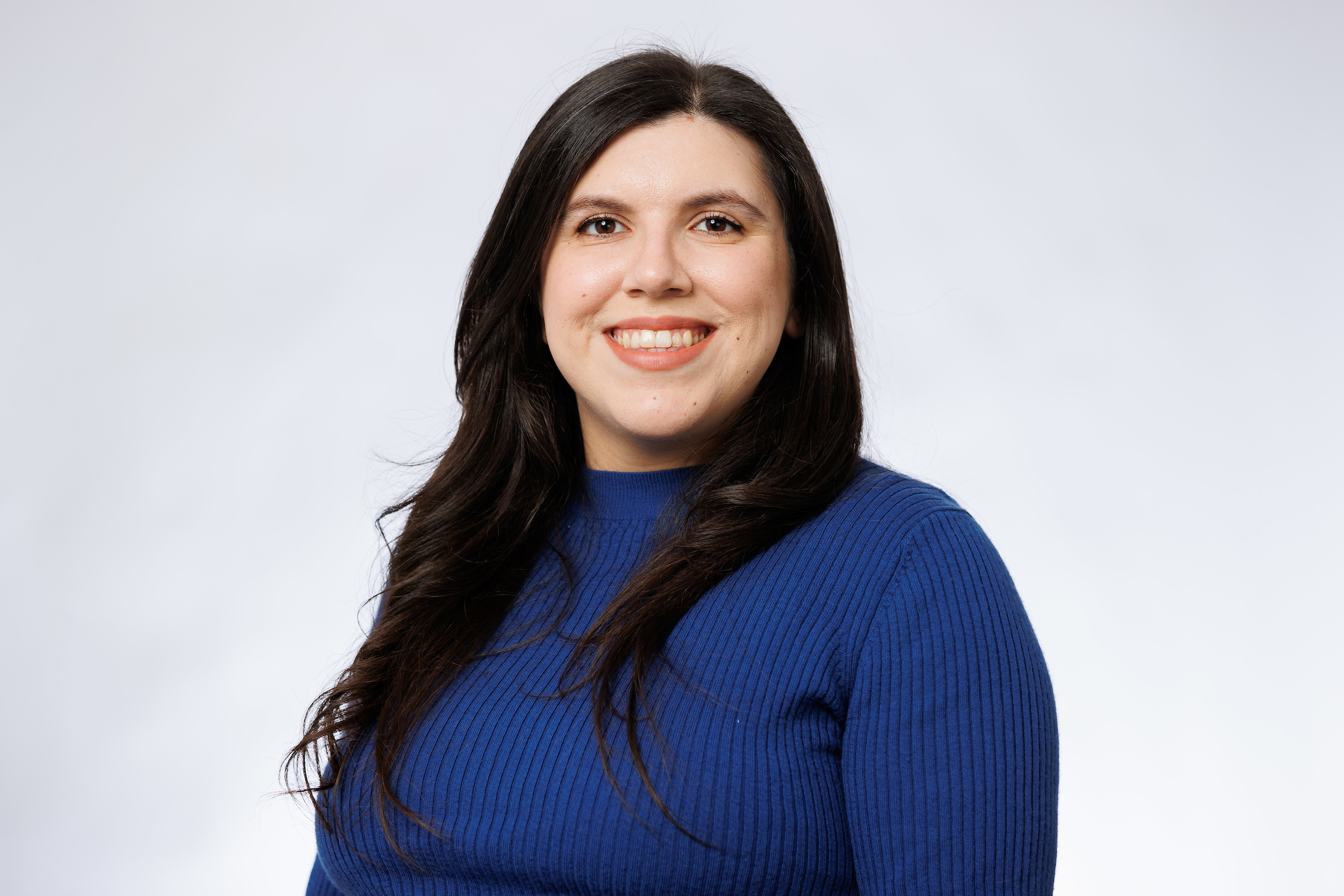 A woman wearing a blue sweater