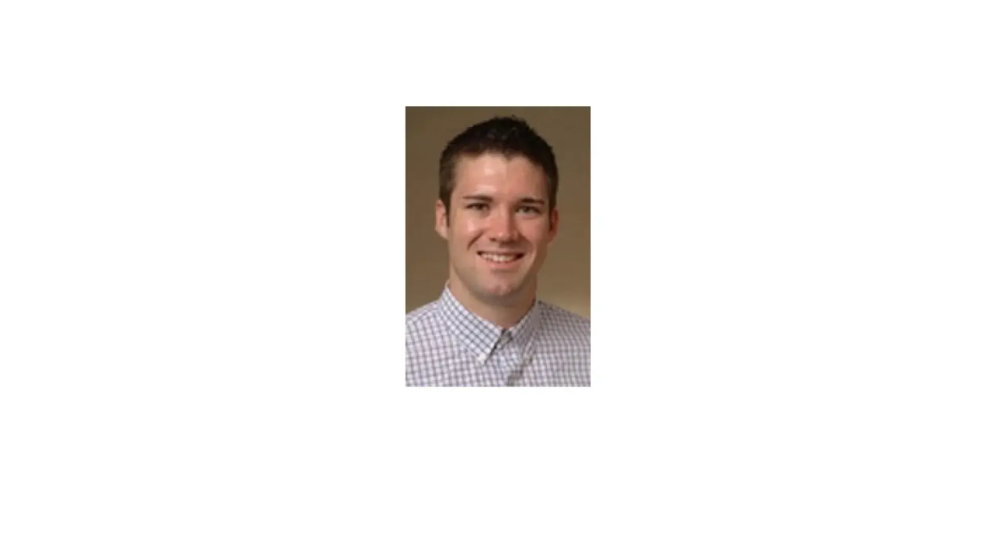 headshot of Christopher, he wears a blue and white checked collared shirt