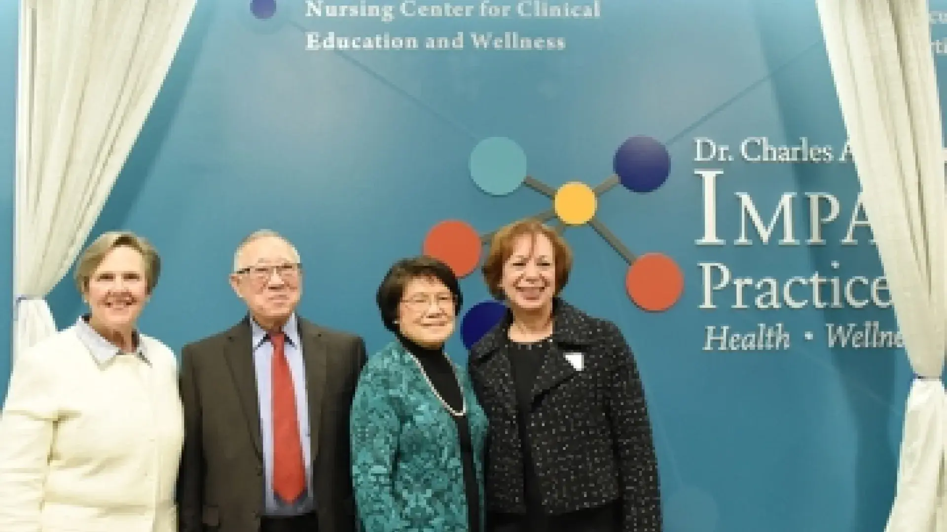 Tom and May Chin, center, with President Paula Milone-Nuzzo (far left) and School of Nursing Dean Inez Tuck (far right), at ceremony to dedicate the Ruth Sleeper Nursing Center for Clinical Education and Wellness.