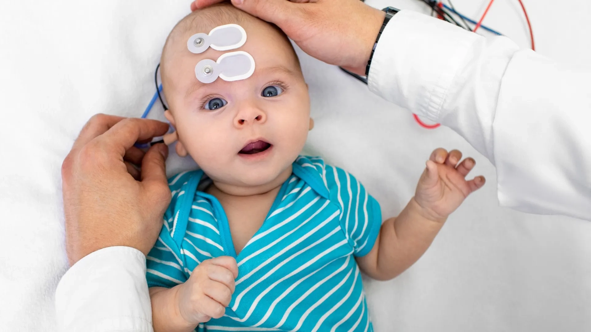 An audiologist conducting a hearing assessment on an infant