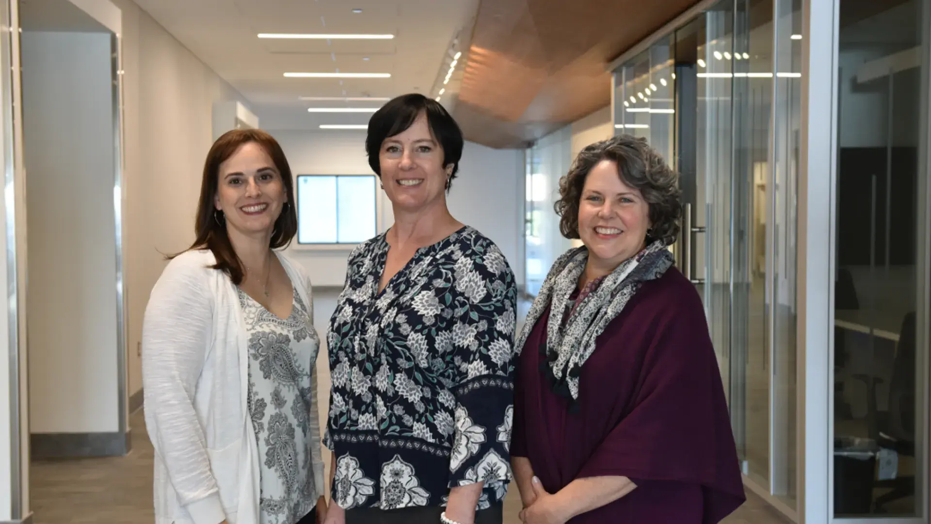Picture of Lisa Moran, Barbara Wilson Arboleda, and Jenn Mackey standing together at IHP
