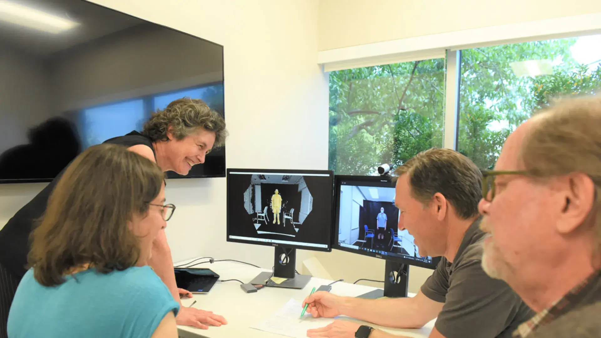 Photo of Dr. Julie Keysor (left) consults with collaborators from Delsys Inc. 