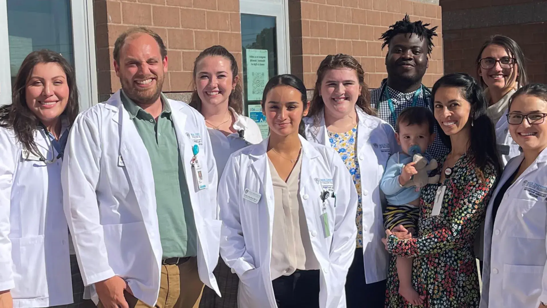 Photo of PA students and faculty as part of Project Access, including Emily Moran, Professor Martha McKean MPH, Ifedayo O. Akinyemi, Olivia Magnussen, Catherine Johnson, Erika Dooley, Emily Medina, Amy Cabrera, and Colby Young.