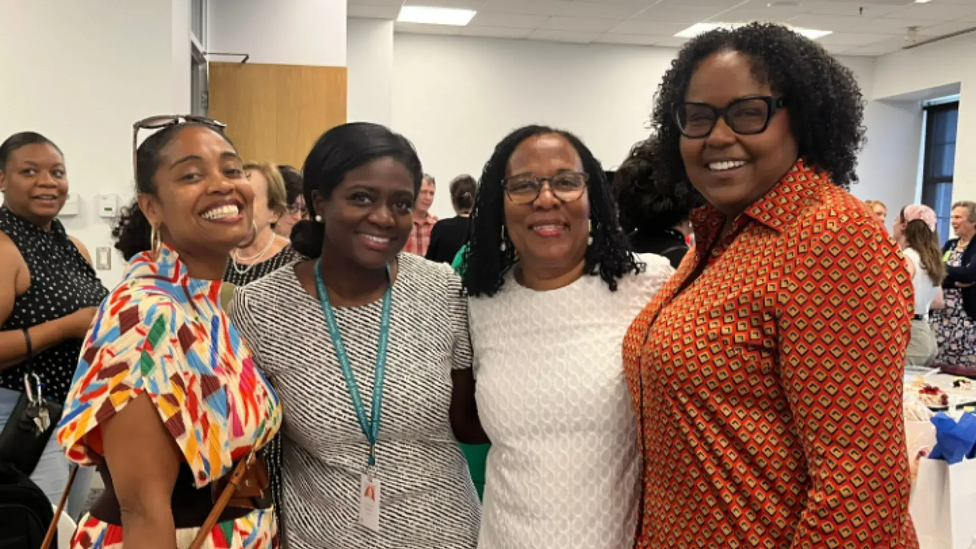 four women smile
