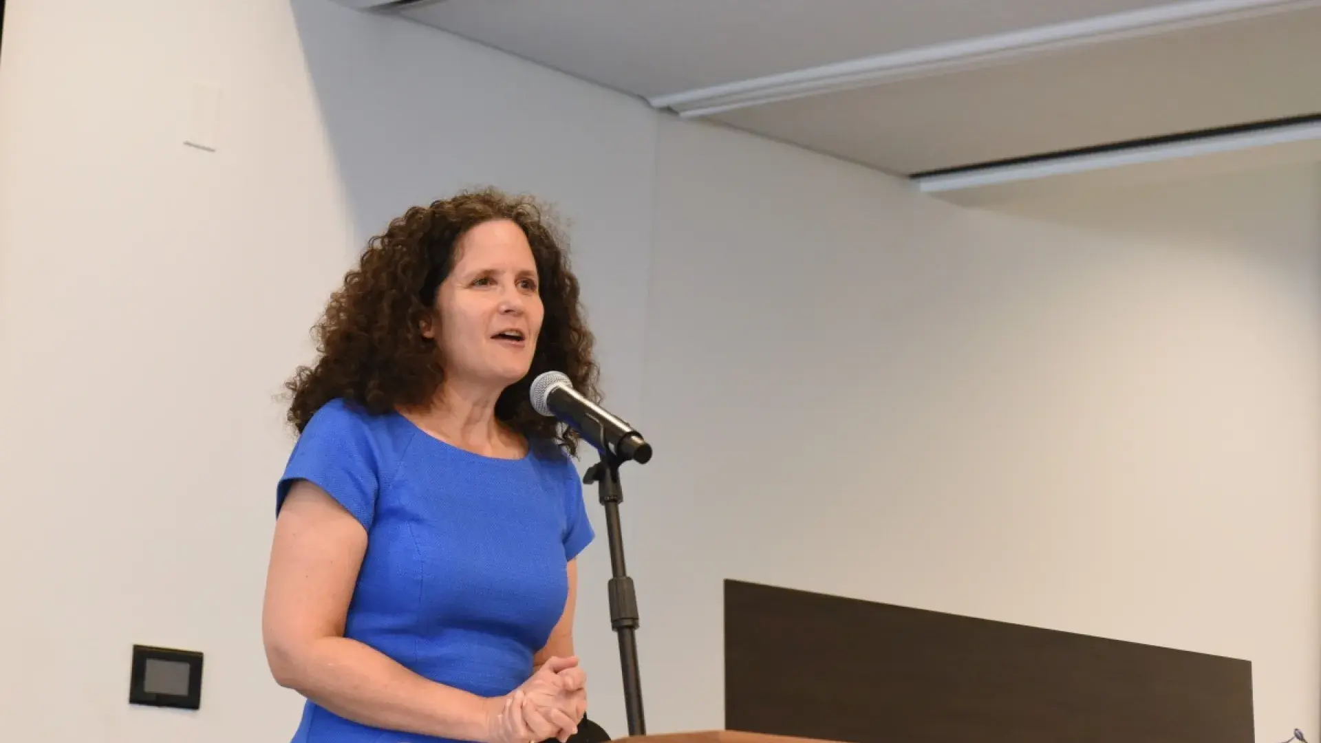 woman talking at podium