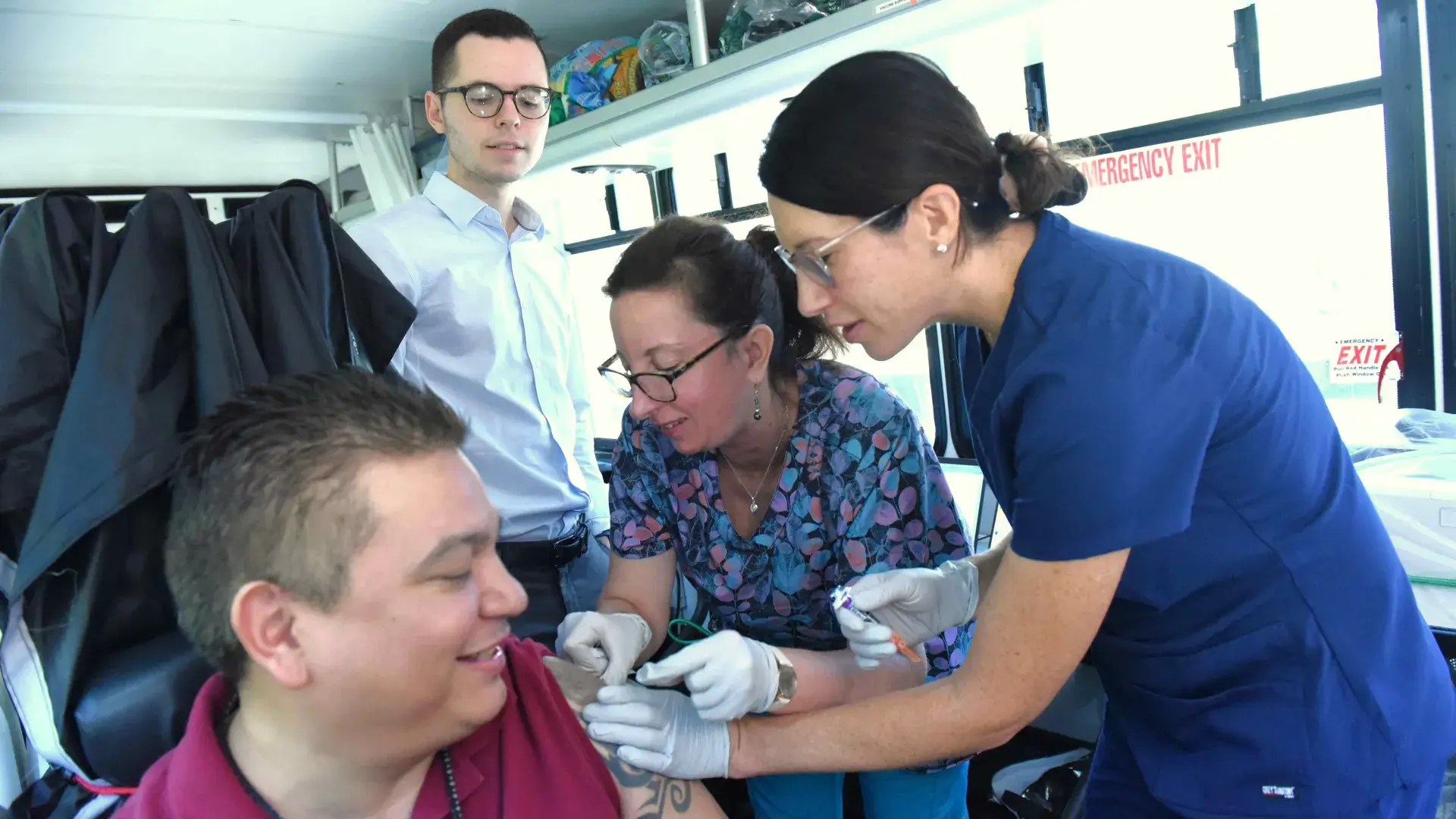 Nurses giving a person a flu shot