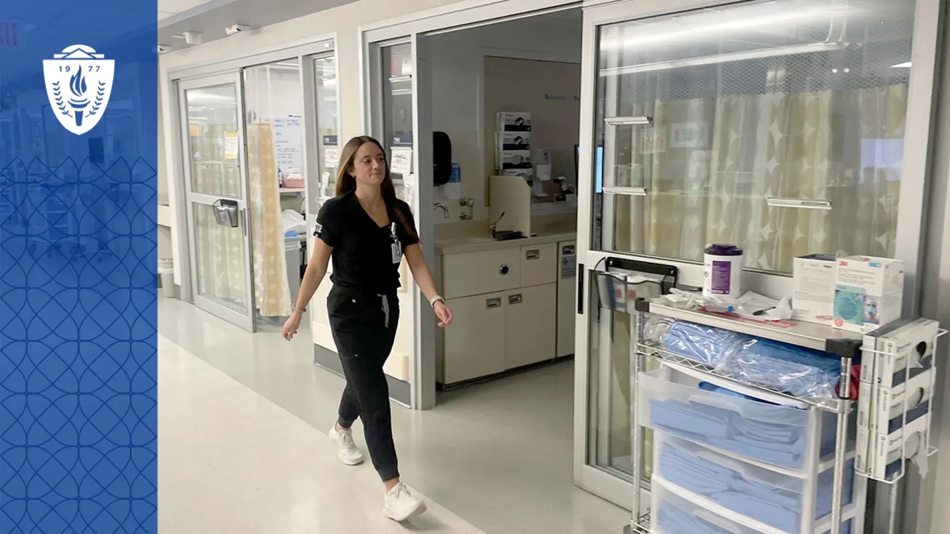 Nursing student at MGH IHP walking through clinical training facility during ABSN program rotation.