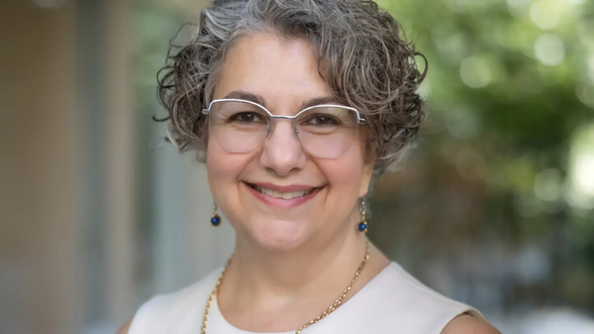 terry has silver rimmed glasses and curly grey hair