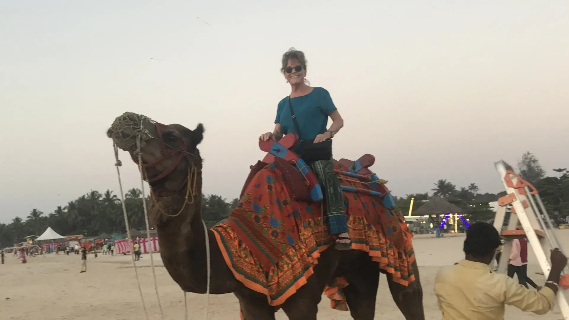 woman sits on a camel 
