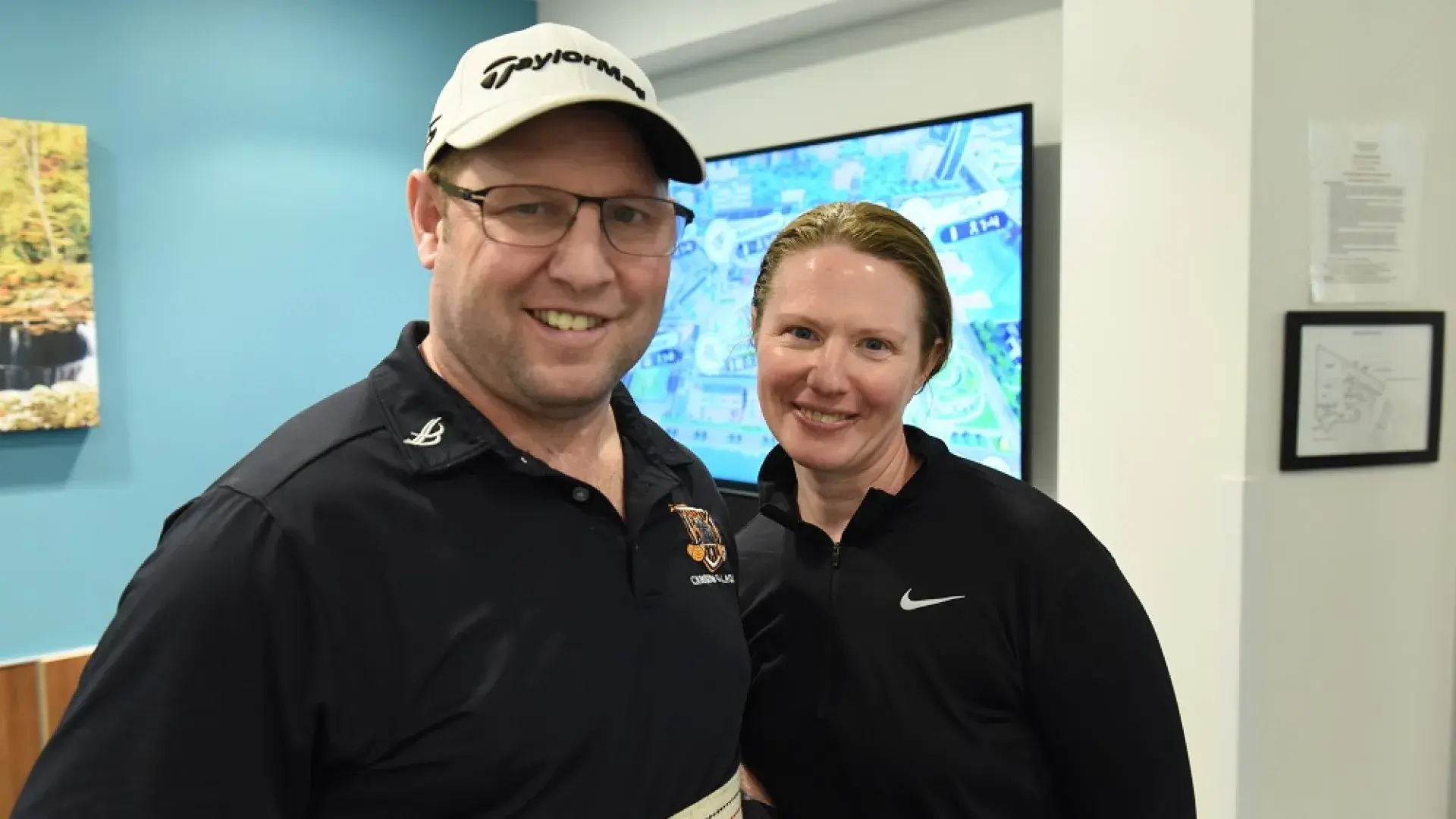 A man stands next to a woman