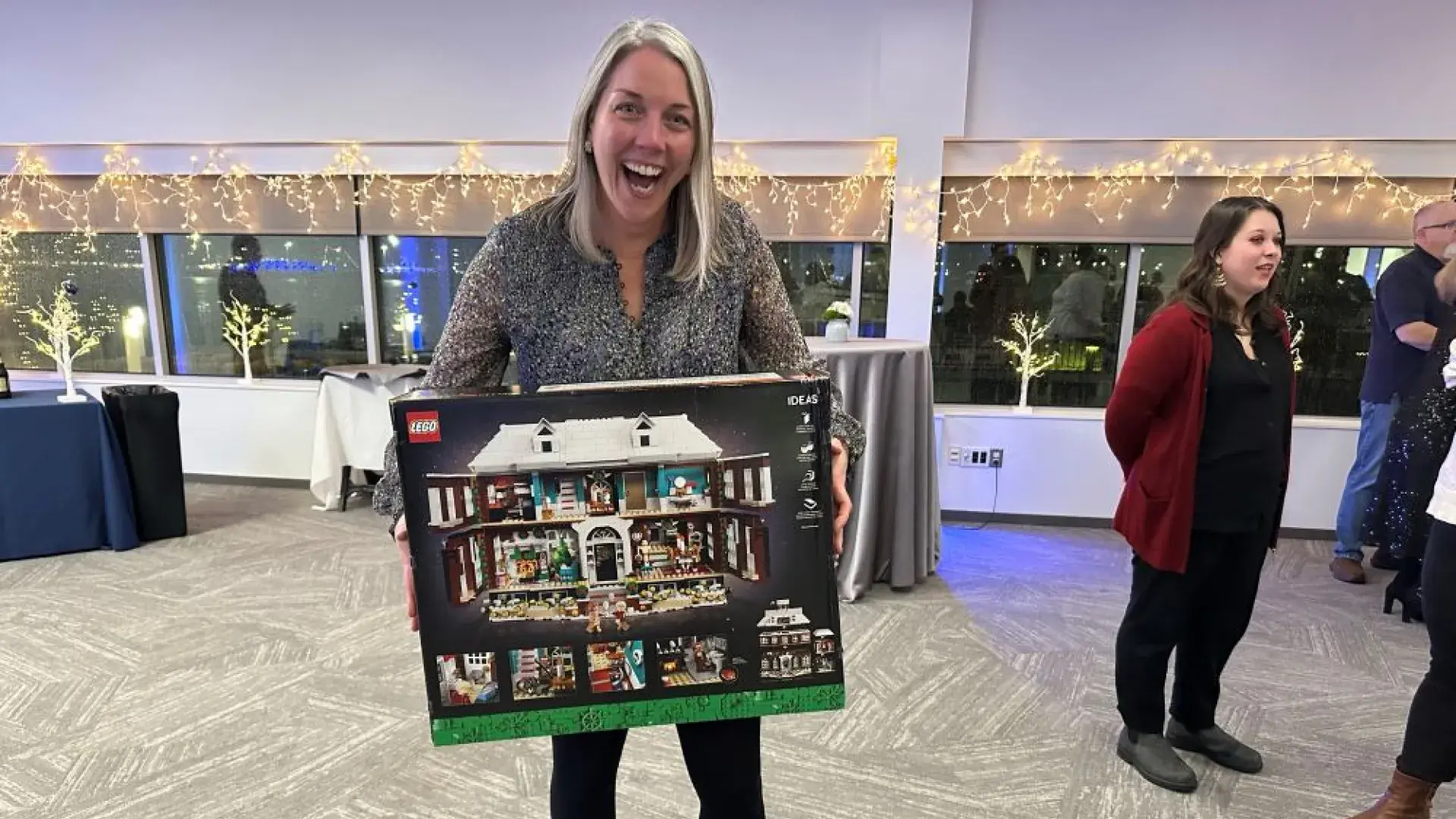 Woman holding box of legos