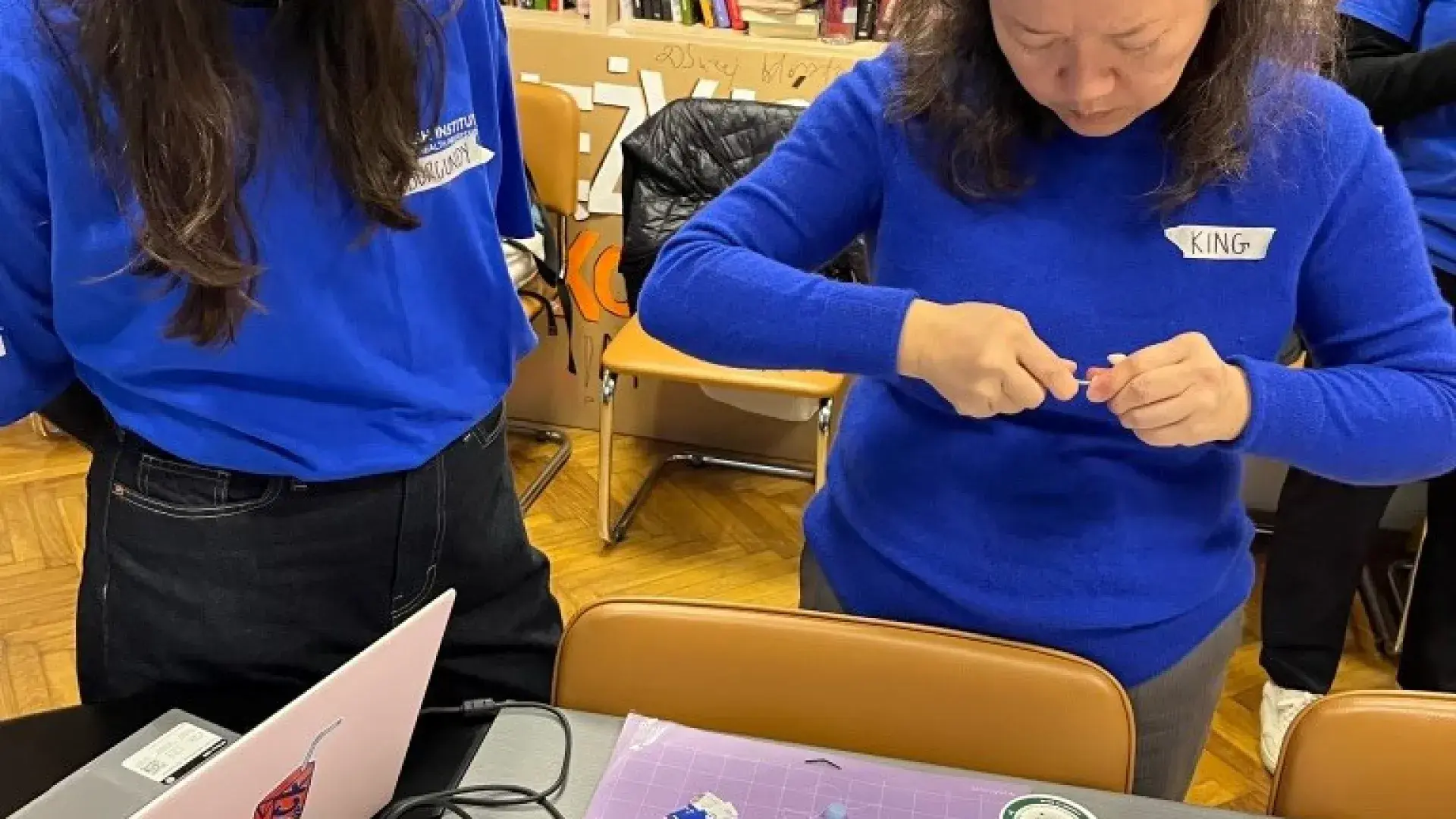 student with professor doing earmold modifications 