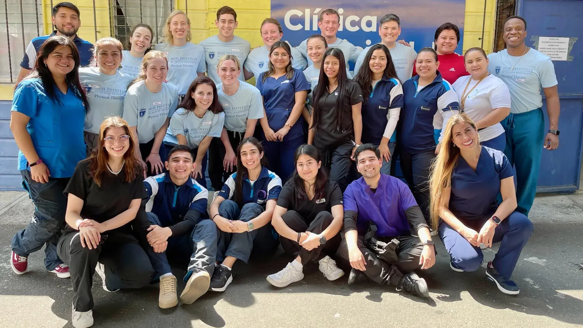 group shot of students faculty outside clinic 