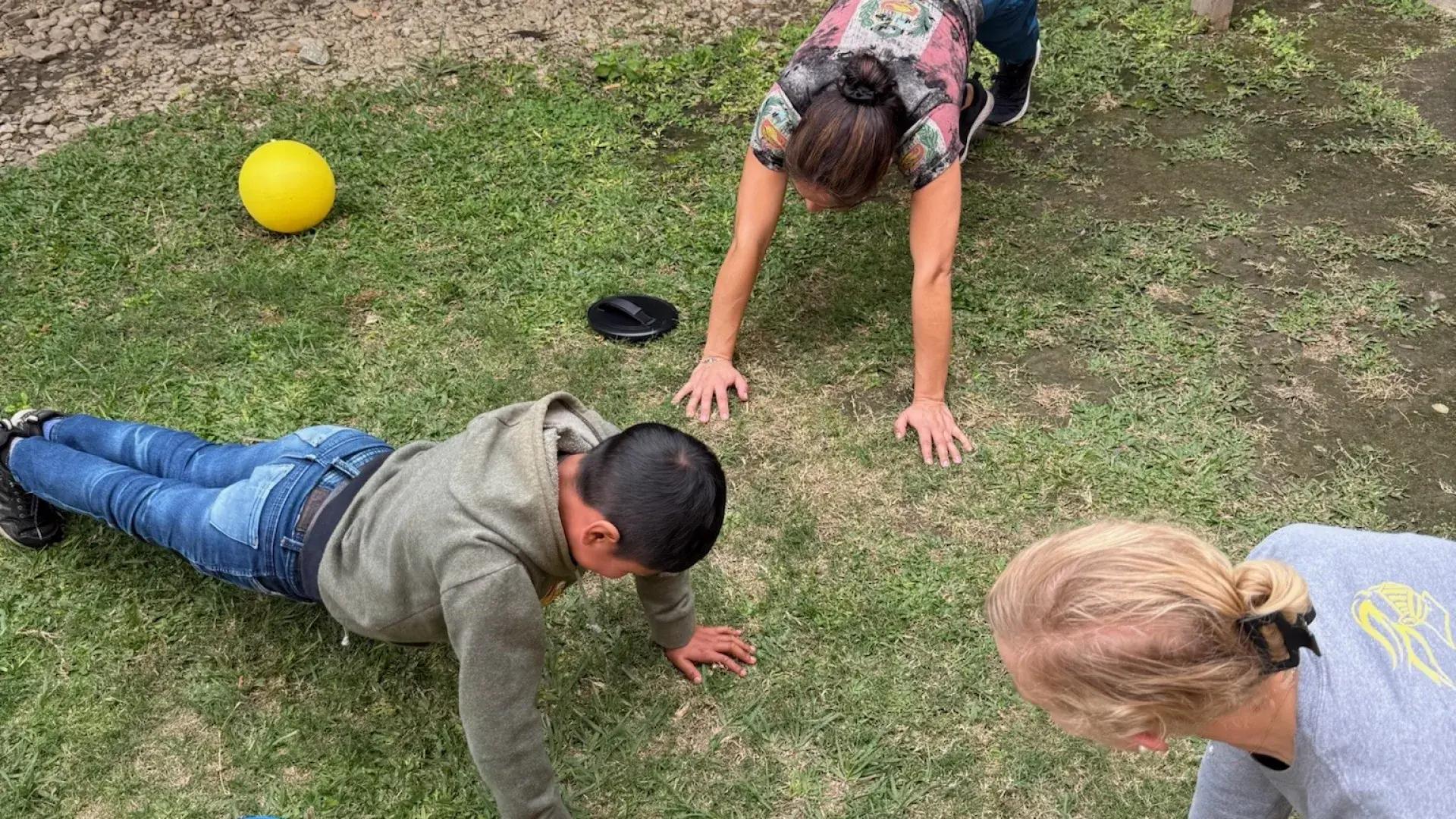 students in pushup formation treating outside with patient 