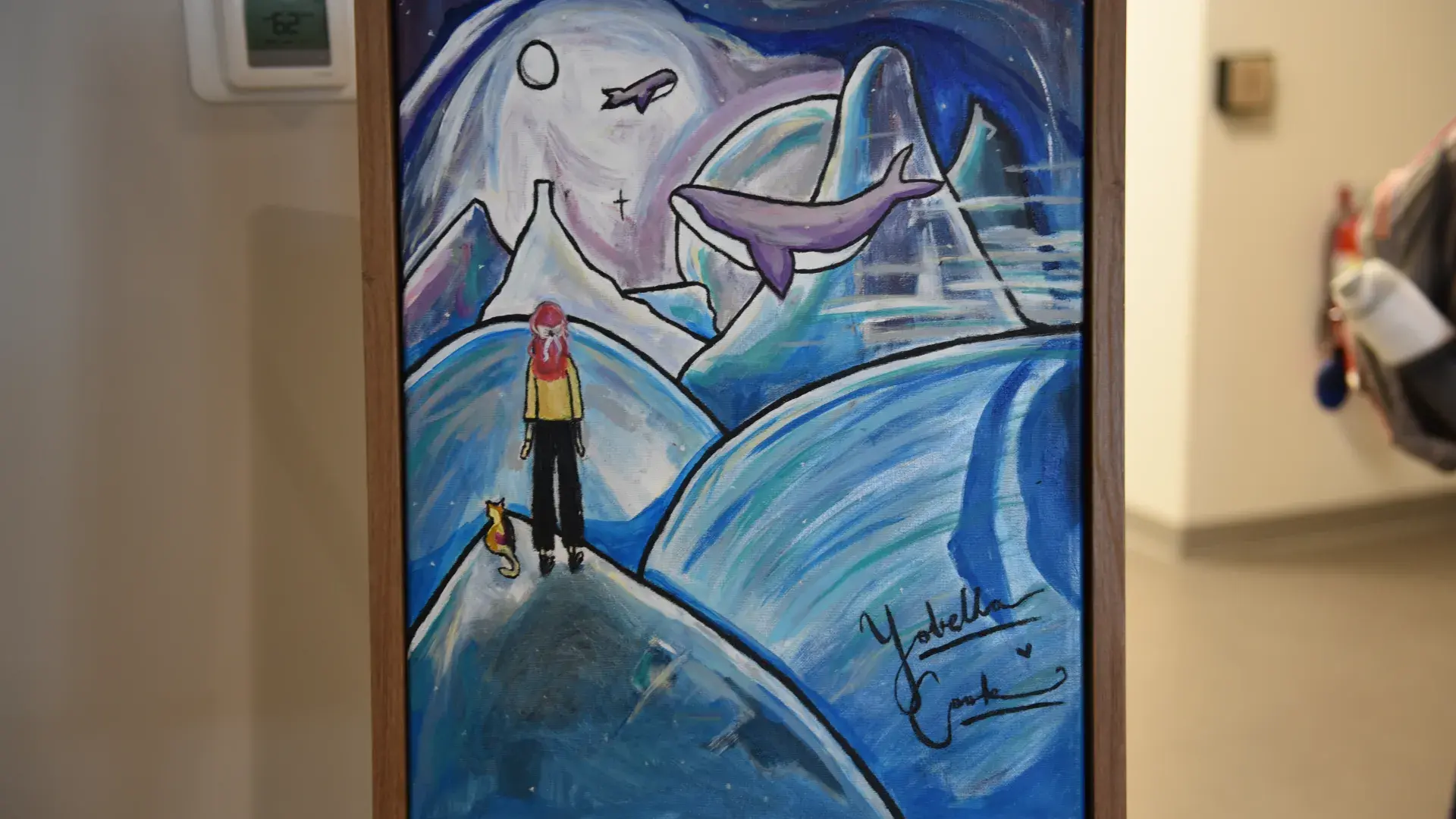 A painting with whales and a person standing on a hill