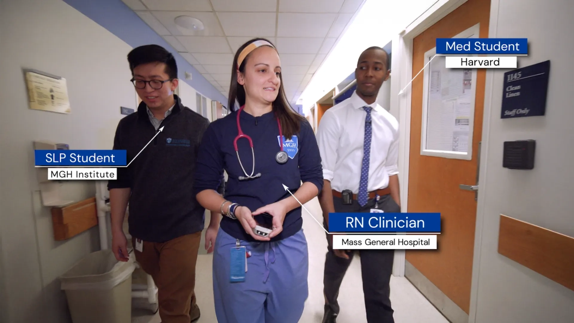 3 people walk down a hallway together, noted to be a SLP Student from Mass General Brigham University, an RN Clinician from MGH, and a med student from Harvard