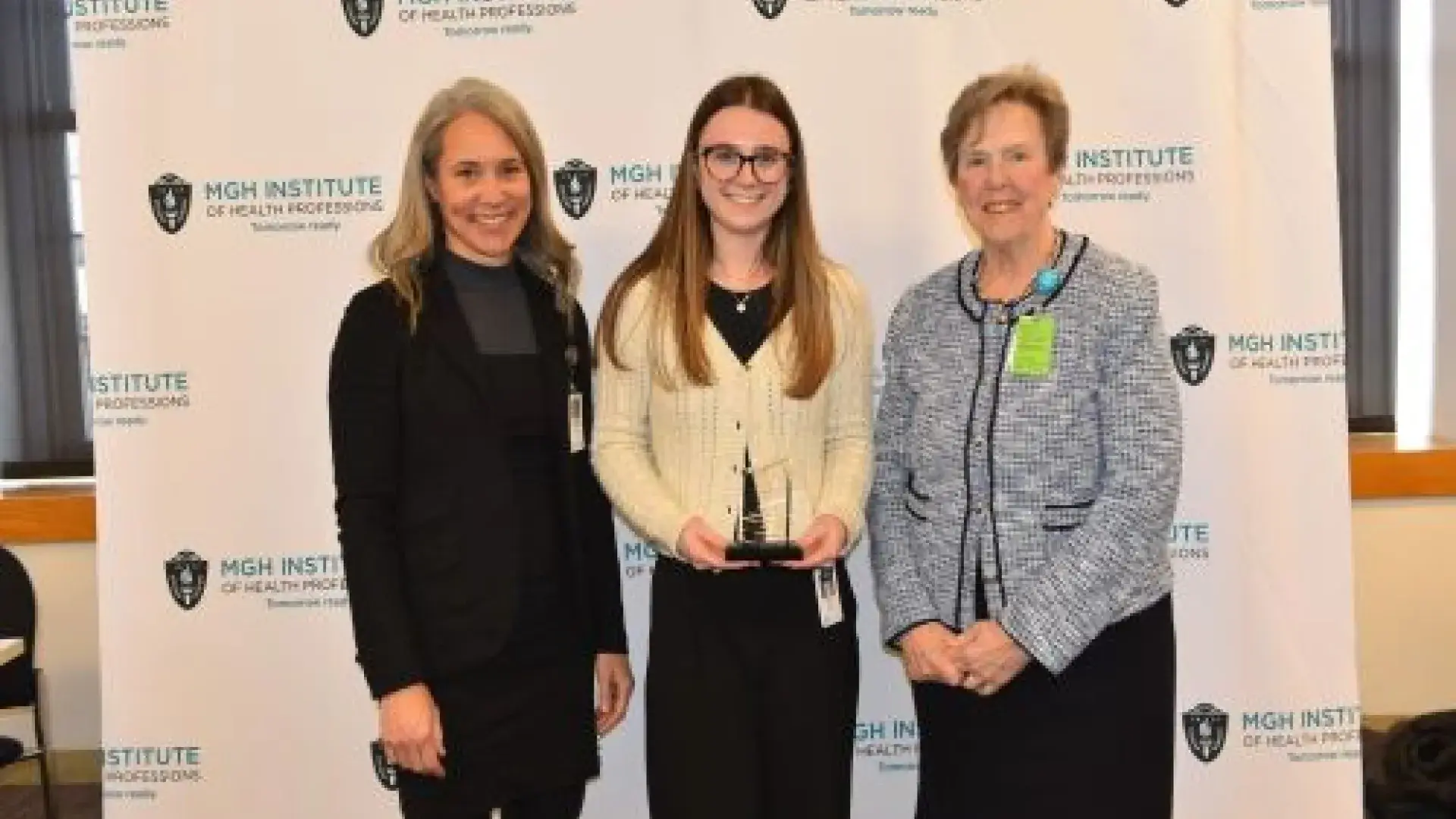 Two women posing with award