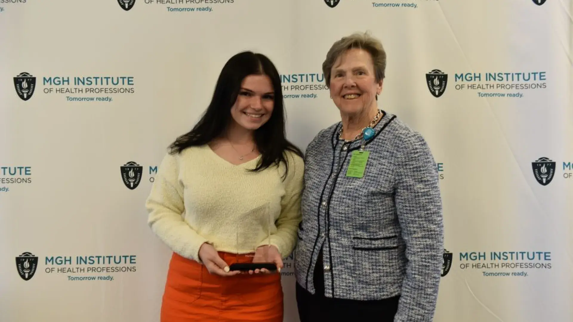 2 women posing with award