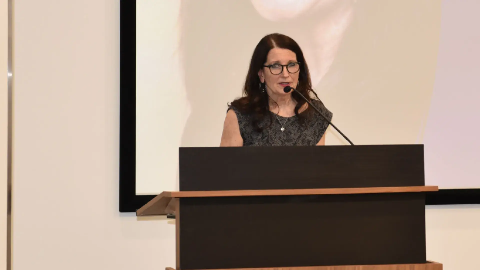 A photo of a woman at a podium