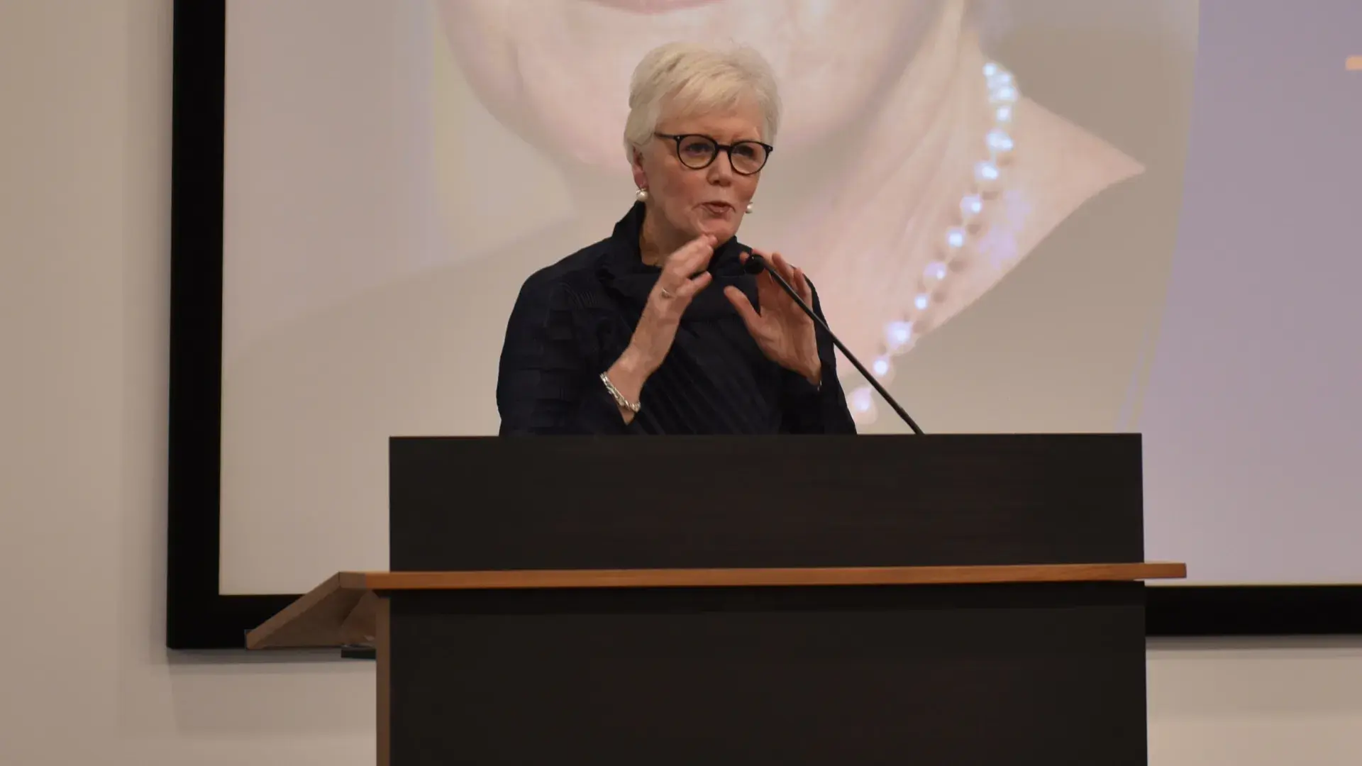 A photo of a woman at a podium
