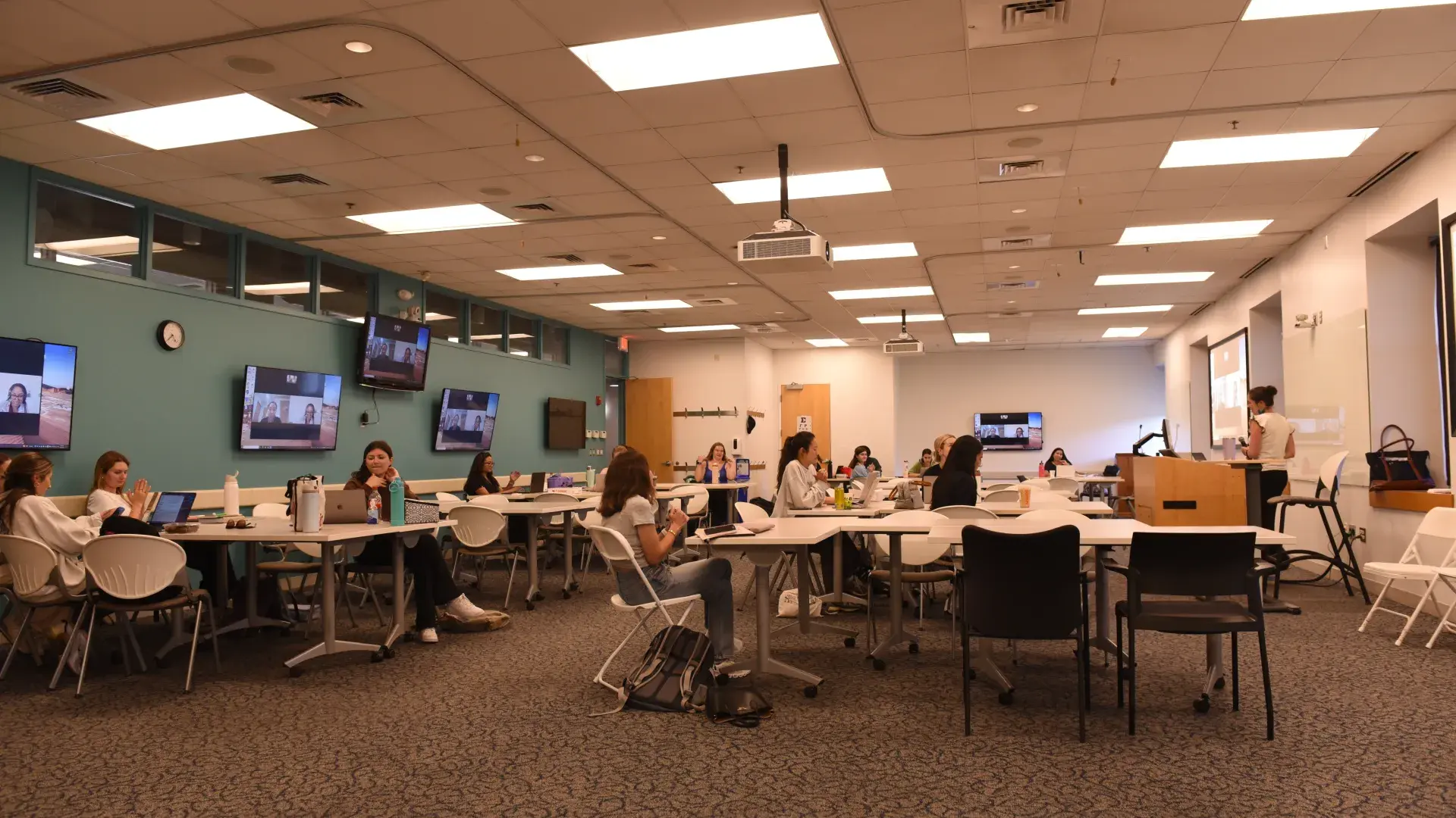 Classroom with tables and chairs and students