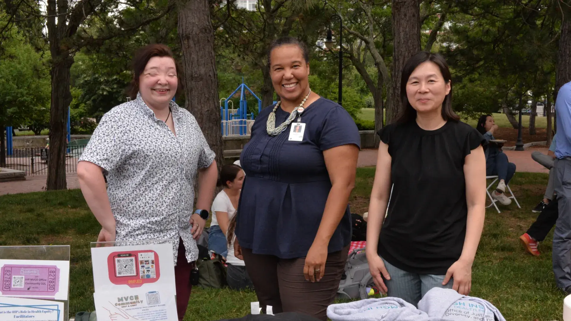 A photo of three women smiling at the camera.