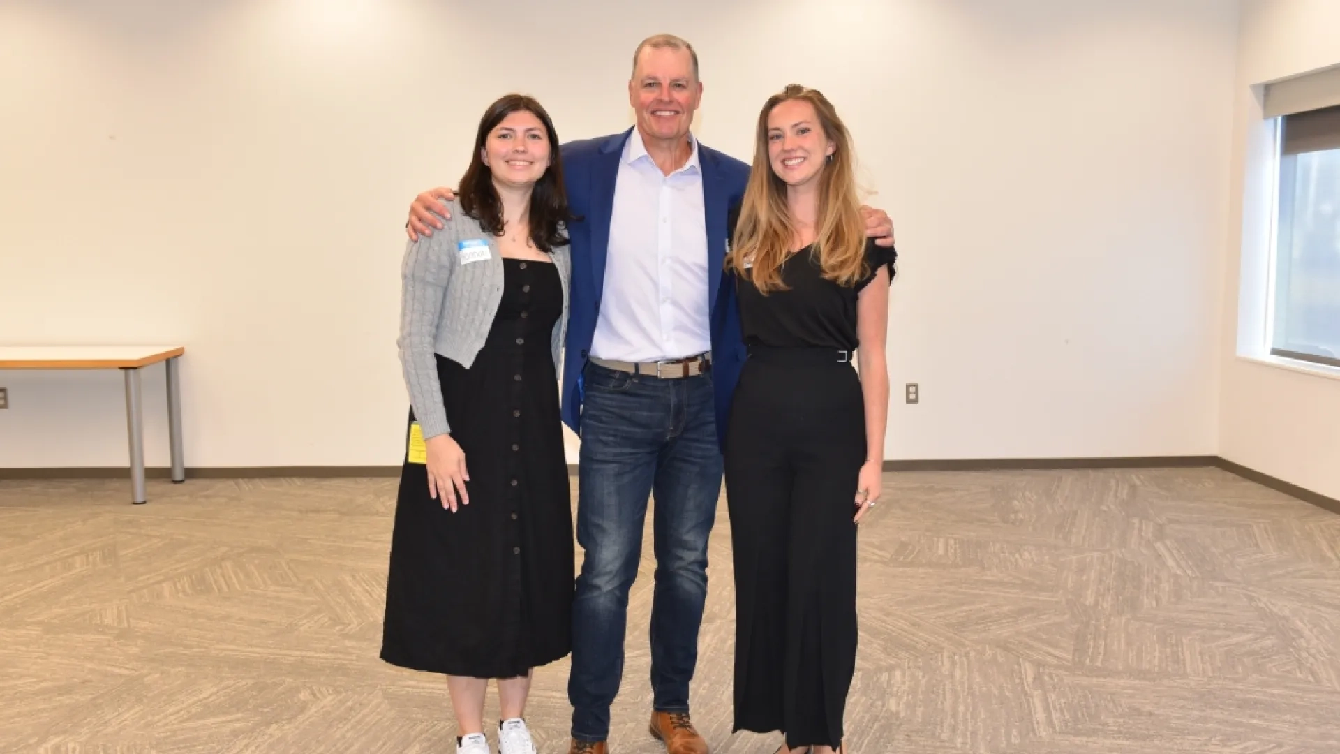 Three people stand next to each other 
