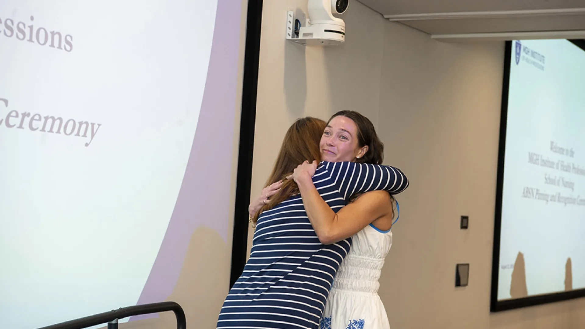 Two women hug 