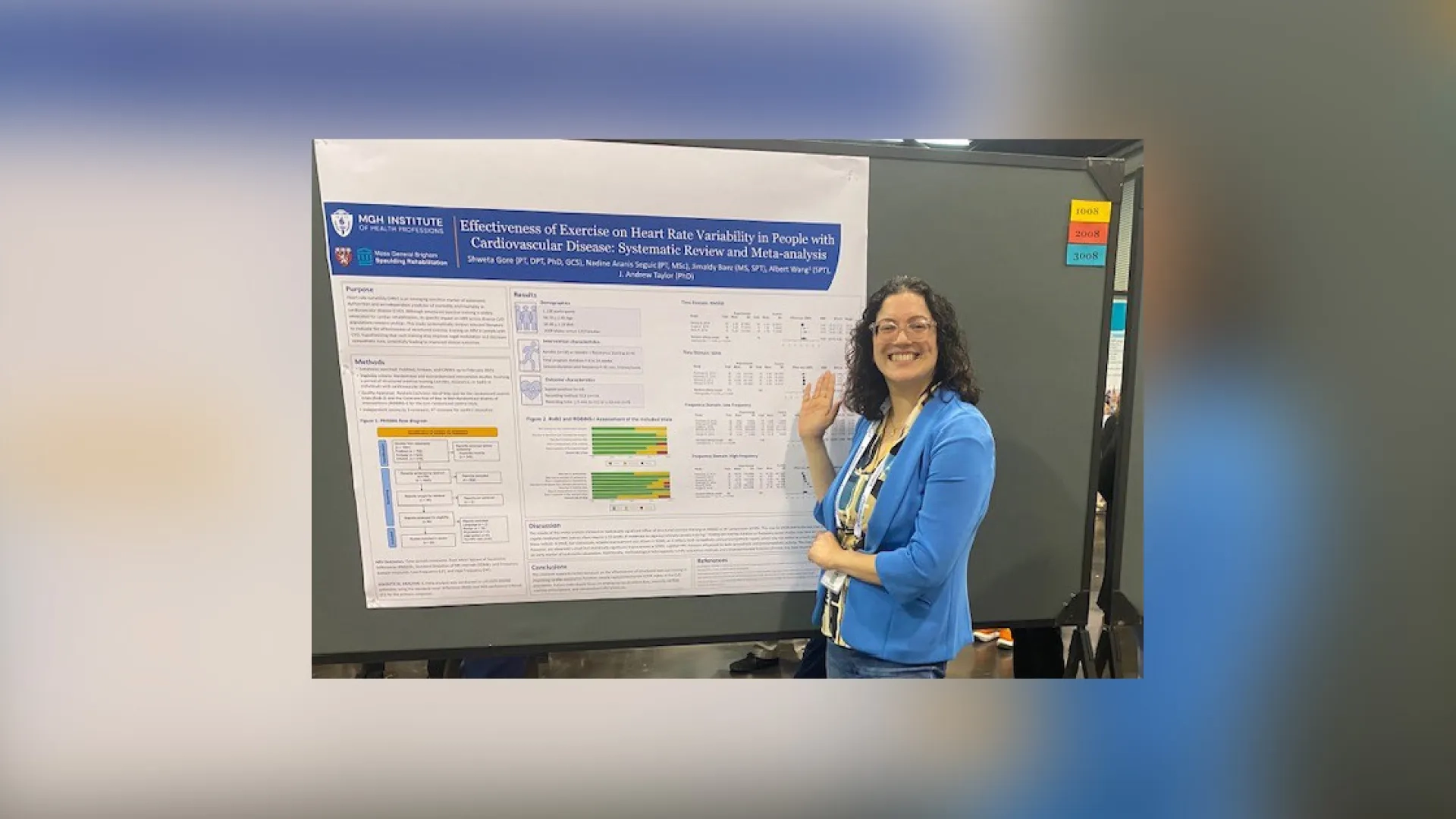 A woman stands in front of a board with a poster on it