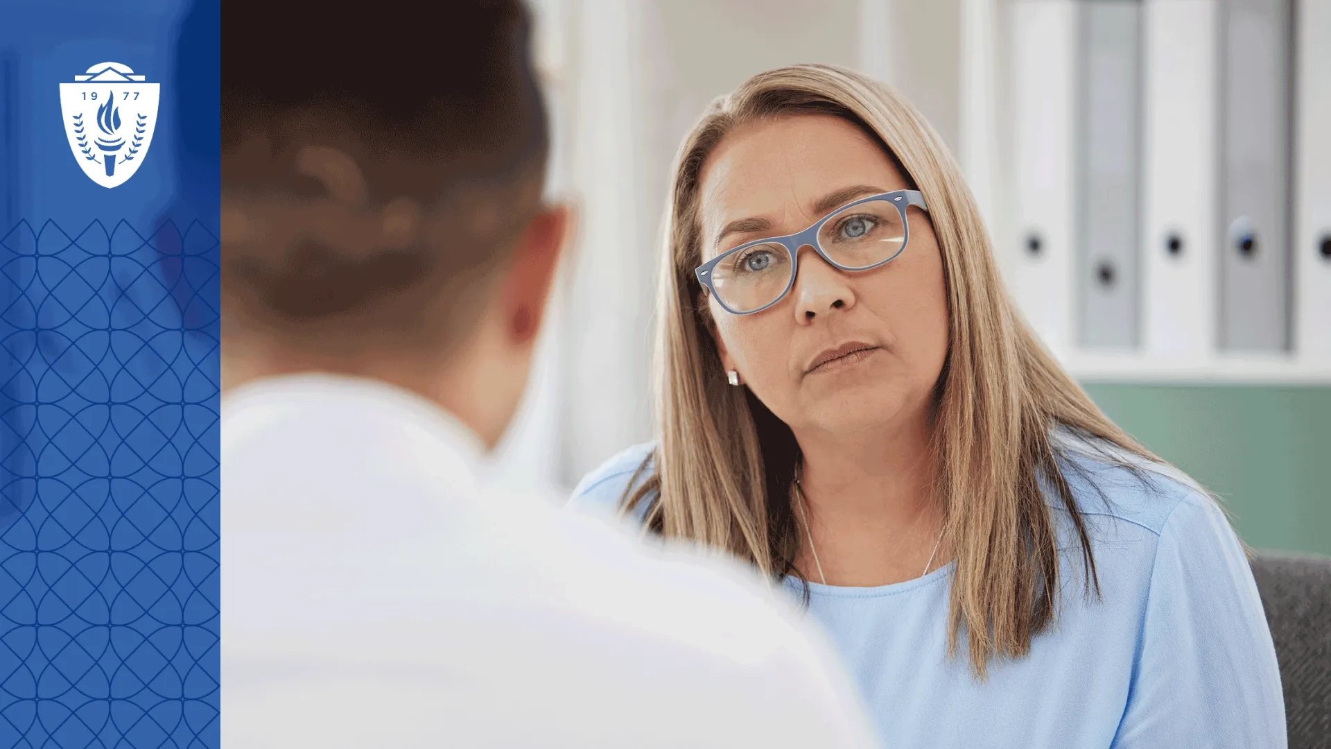 Woman with long blonde hair, glasses, and a blue shirt working with a behavoiral health paraprofessional