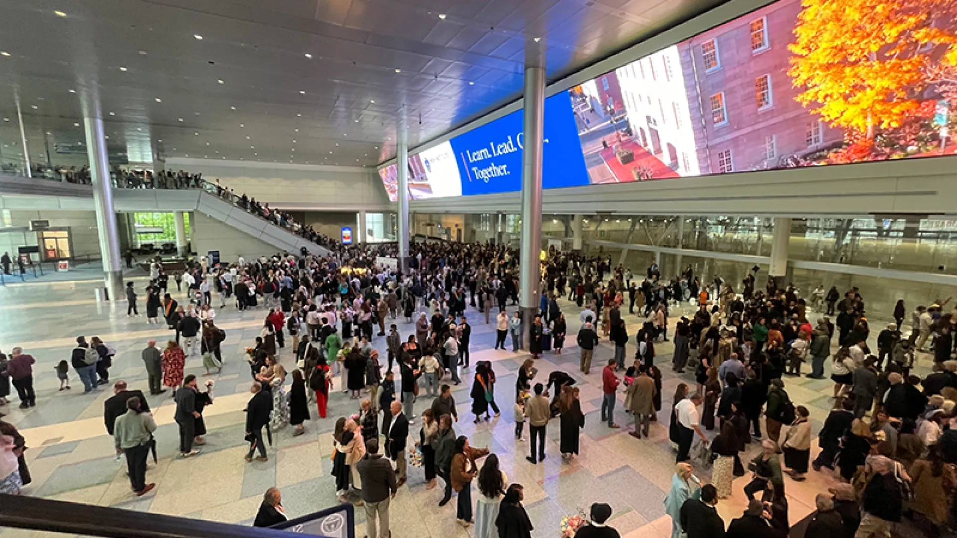 Overhead shot of graduates with family in a large space