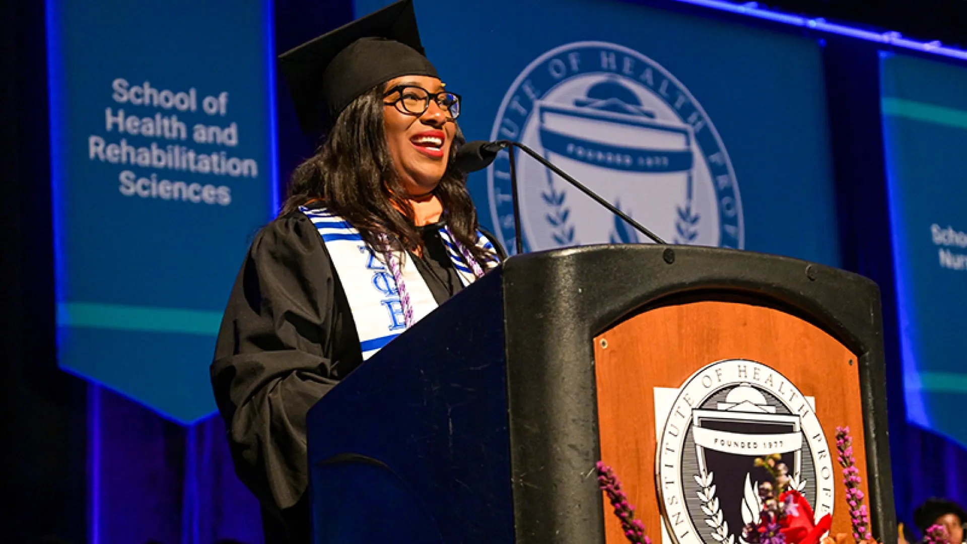 Tiffany Vassell at the podium at commencement