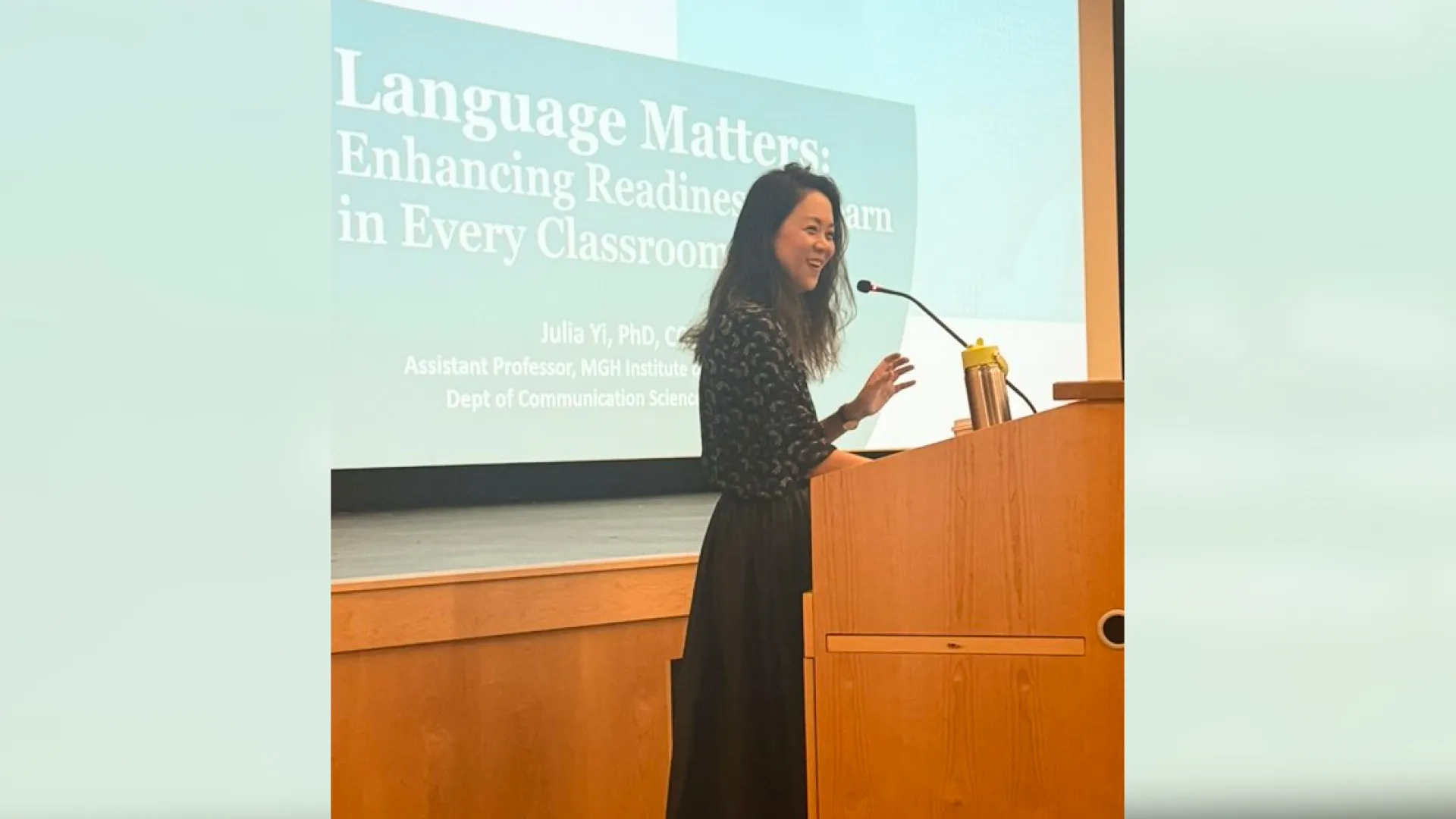 An MGH Institute researcher speaks about literacy at a podium